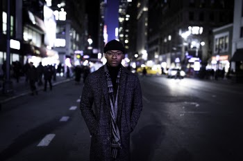 Man Wearing Gray Coat Standing in the Middle of the Road