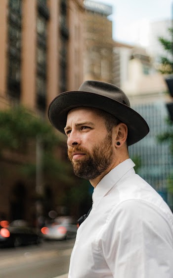 Man Wearing Gray Fedora Hat Out In The City 
