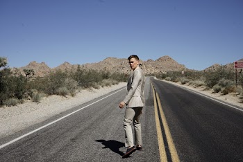 Man Wearing Gray Formal Suit Walking on Asphalt Road