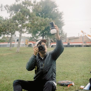 Man Wearing Gray Jacket Holding Dslr Camera