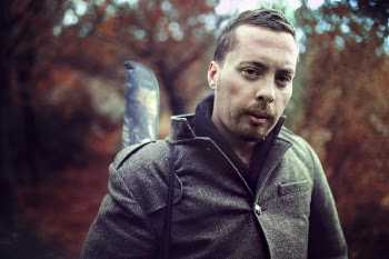 Man Wearing Gray Jacket in Front of Trees