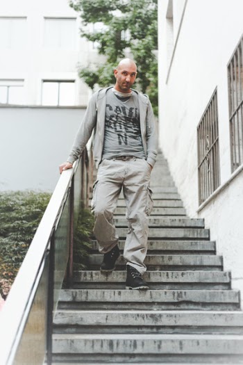 Man Wearing Gray Jacket Standing on Stair