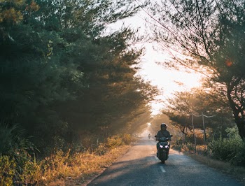 Man Wearing Gray Shirt Riding Motorcycle