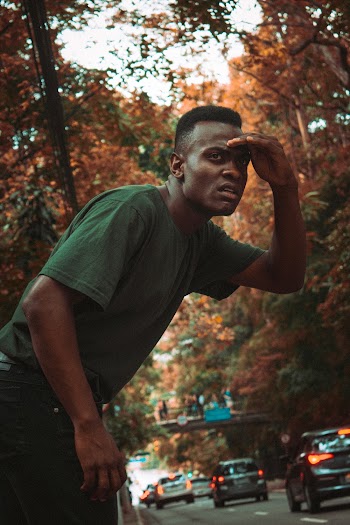 Man Wearing Green Crew-neck Shirt Seeing on Street