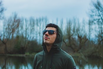 Man Wearing Green Hoodie and Black Sunglasses
