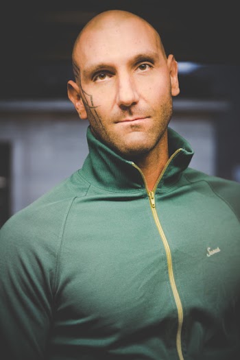 Man Wearing Green Zip-up Top