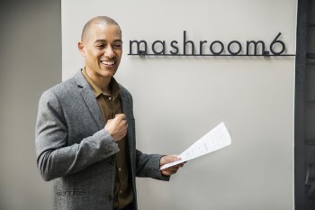 Man Wearing Grey Notched Lapel Suit Jacket Holding White Printer Paper While Standing