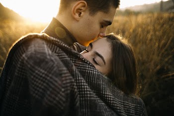 Man Wearing Grey Shirt Hugging Woman Outside Ner Crops