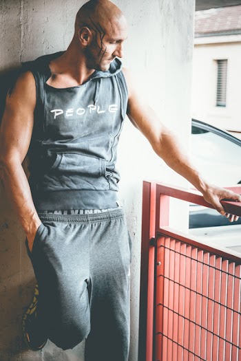 Man Wearing Grey Sleeveless Hoodie and Grey Sweatpants