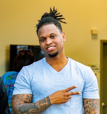 Man Wearing Grey V-neck Shirt With Body Tattoos