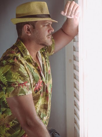 Man Wearing Hat and Leaning Against Wall