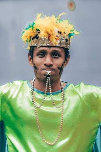 Man Wearing Headdress With Whistle In His Mouth