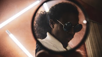 Man Wearing Hippie Sunglasses Seen Through Mirror