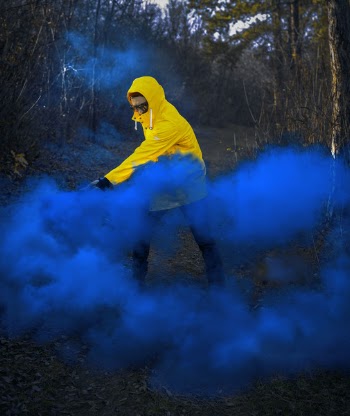 Man Wearing Hoodie Near Blue Smoke