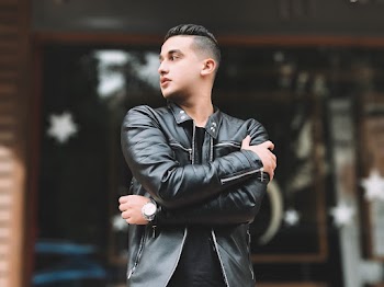 Man Wearing Leather Jacket And Looking Towards Left