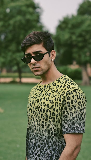Man Wearing Leopard Print Shirt And Black Sunglasses 