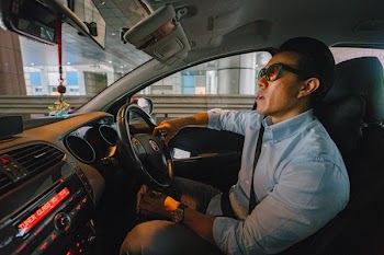 Man Wearing Light Blue Button-down Dress Shirt Driving Vehicle