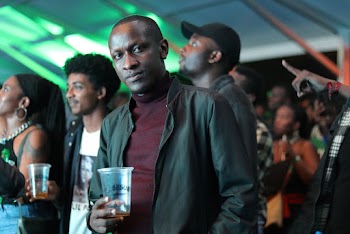 Man Wearing Maroon Shirt and Black Jacket
