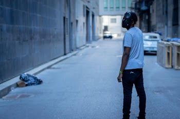 Man Wearing Mask in Alley
