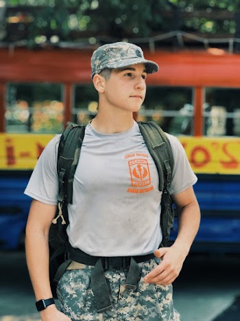 Man Wearing Military Uniform Carrying a Backpack
