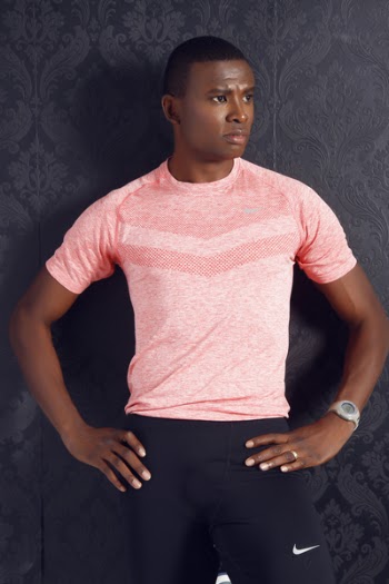 Man Wearing Pink Crewneck Shirt and Black Nike Shorts Standing