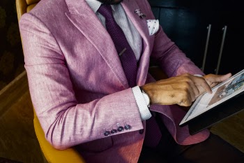 Man Wearing Pink Suit Jacket Holding Using Tablet Computer