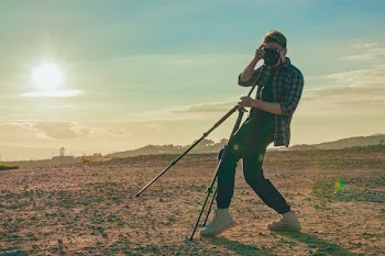 Man Wearing Plaid Sport Shirt Taking a Photo