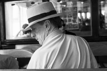 Man Wearing Polo Shirt and Hat in Grayscale Photo
