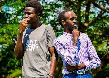 Man Wearing Purple Dress Shirt Standing Near Man in Gray Shirt