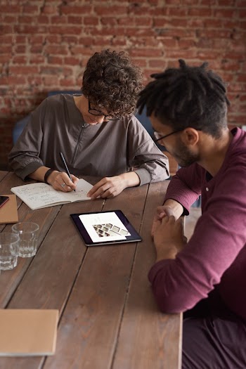 Man Wearing Purple Long-sleeved Shirt Looking at the Ipad