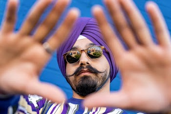 Man Wearing Purple Turban and Black Clubmaster Sunglasses