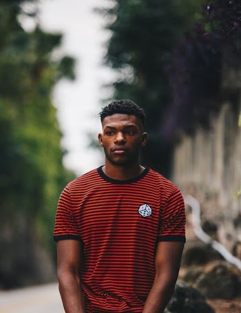 man wearing red and black striped ringer shirt