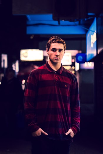 Man Wearing Red and Maroon Striped Long-sleeved Polo Shirt Holding Pockets
