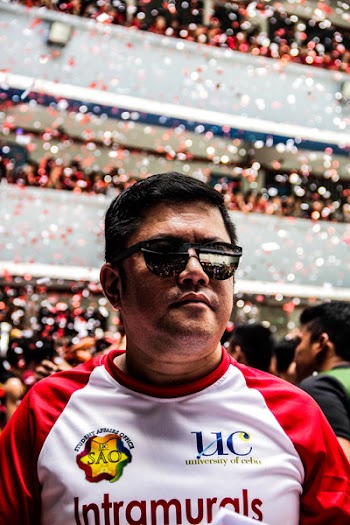 Man Wearing Red and White Top and Black Sunglasses