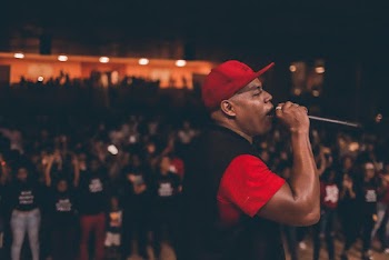 Man Wearing Red Cap Holding Black Microphone