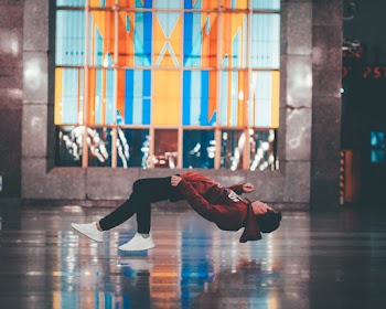 Man Wearing Red Hoodie and Black Pants Close-up Photography