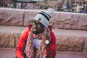 Man Wearing Red Jacket Sitting On Steps