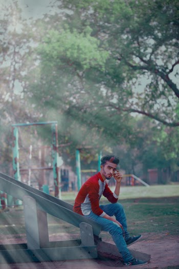 Man Wearing Red Long-sleeved Shirt Sitting On Slide