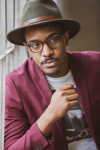 Man Wearing Red Notch Lapel Suit Jacket And Black Fedora Hat