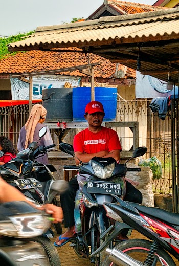 Man Wearing Red Shirt Riding A Motorcycle