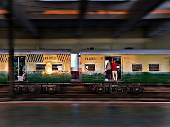 Man Wearing Red Shirt Standing By The Door Of A Train