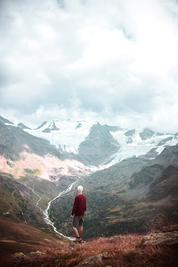 Man Wearing Red Sweater Standing on Hill