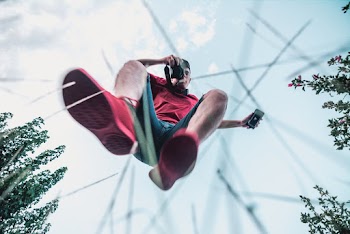 man wearing Red T-shirt and Black Shorts
