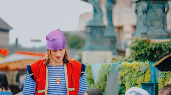 Man Wearing Red Vest And Blue Striped Shirt
