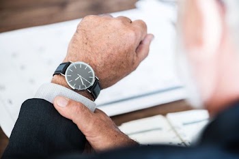 man wearing round watch at 9:36