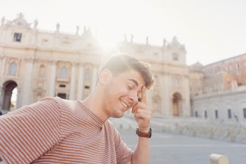 Man Wearing Striped T-shirt Touching His Forehead