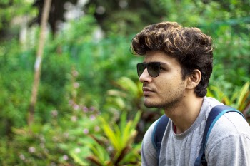 Man Wearing Sunglasses and Grey Shirt Taking Selfie at the Forest