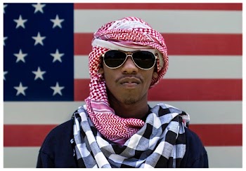 man wearing sunglasses in front of American flag