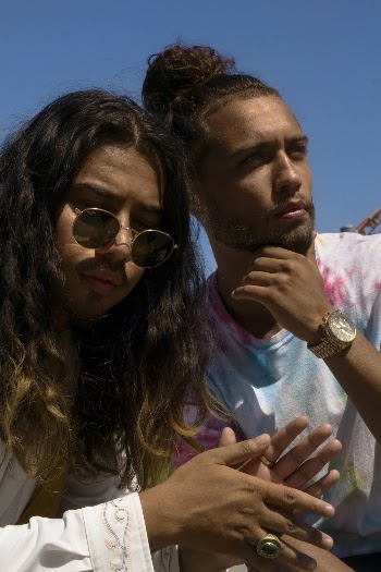 Man Wearing Sunglasses Sitting Beside Man In Tie-dye Crew Neck Shirt
