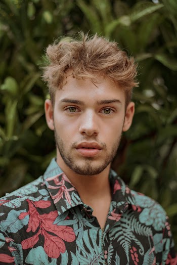 Man Wearing Teal and Pink Floral Collared Top
